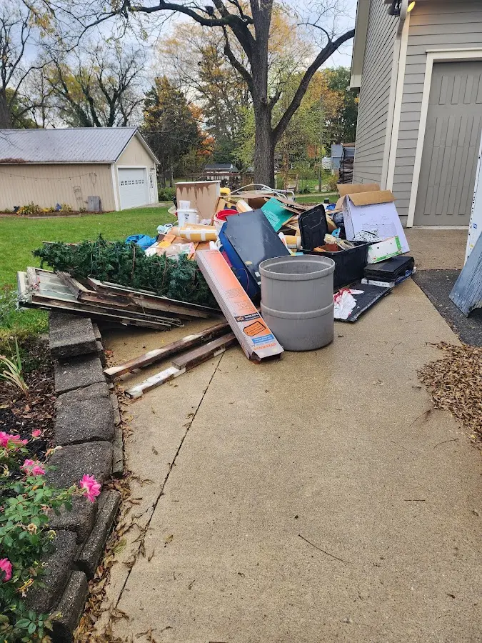 Dumpster being loaded with debris for 3 Yard Dumpster Rental in Farmington
